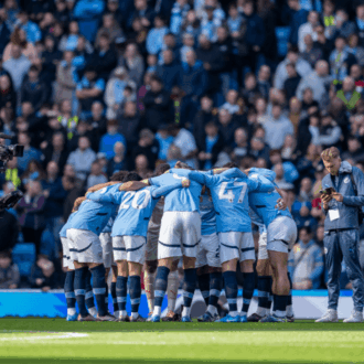Manchester City players in a huddle before kick-off.