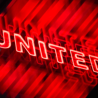 Red lights of Manchester United outside Old Trafford.