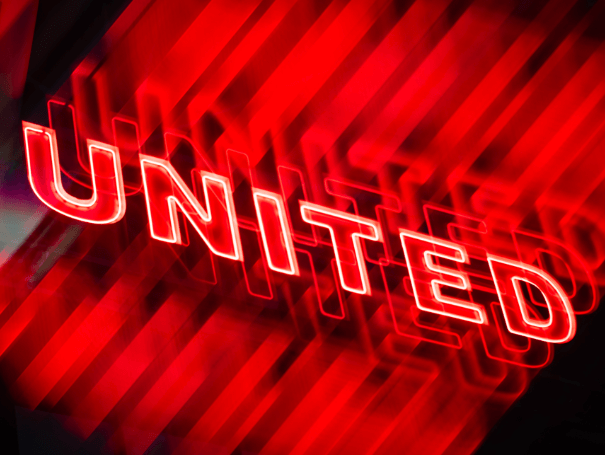 Red lights of Manchester United outside Old Trafford.