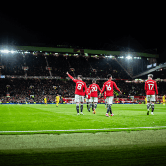 Manchester United players celebrating a goal.