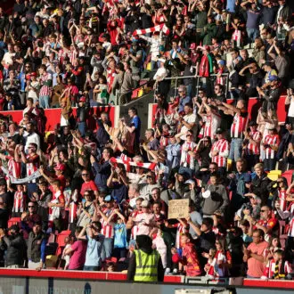 Brentford FC fans celebrating victory over Wolverhampton Wanderers in the Premier League 24/25 season.