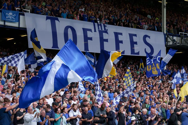 Everton supporters at Goodison Park with a banner with 'The Toffees' on it.