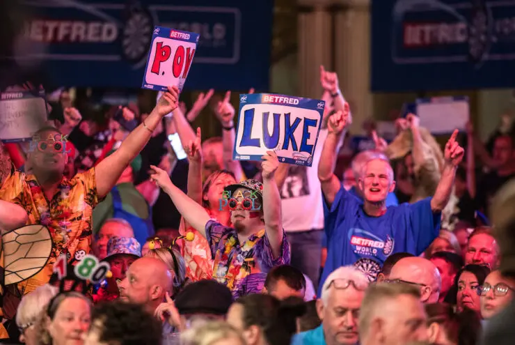 Fans holding up signs for their favourite darts stars at the World Matchplay Darts in Blackpool.