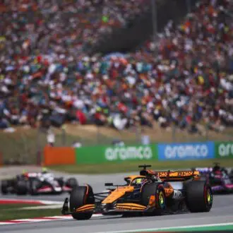 F1 Spanish Grand Prix action shot with crowd watching on in the background.