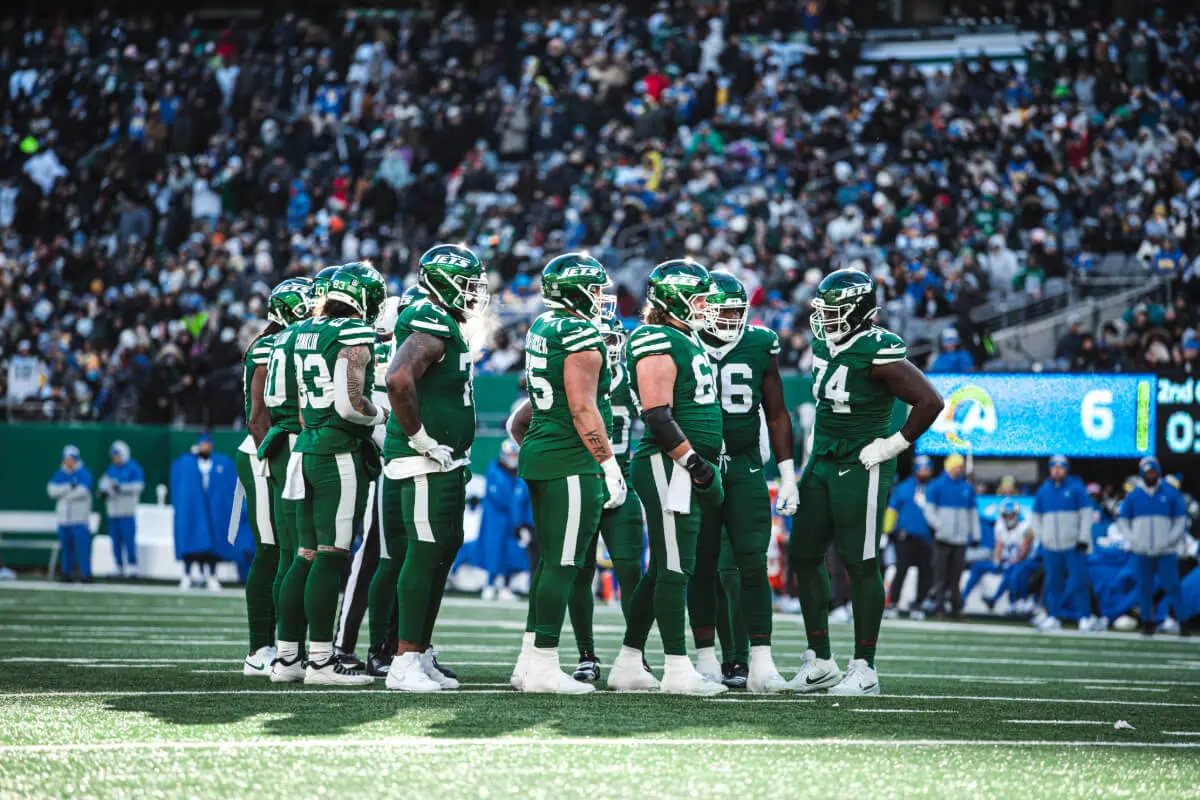 New York Jets players huddle together at the MetLife