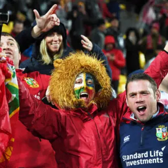 Lions fans celebrating in the stands.