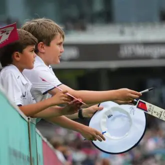 Children with signed merchandise from players at Lord's Cricket Ground.