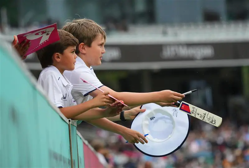Children with signed merchandise from players at Lord's Cricket Ground.