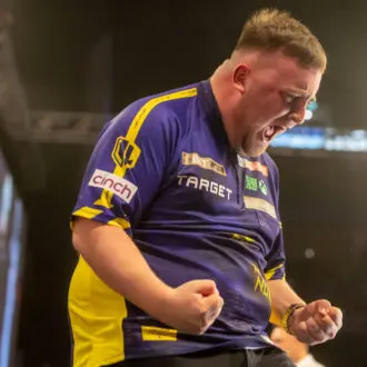 Littler celebrates passionately at the Premier League darts 2025.