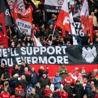 Manchester United fans at Old Trafford with 'We'll support you evermore' banner