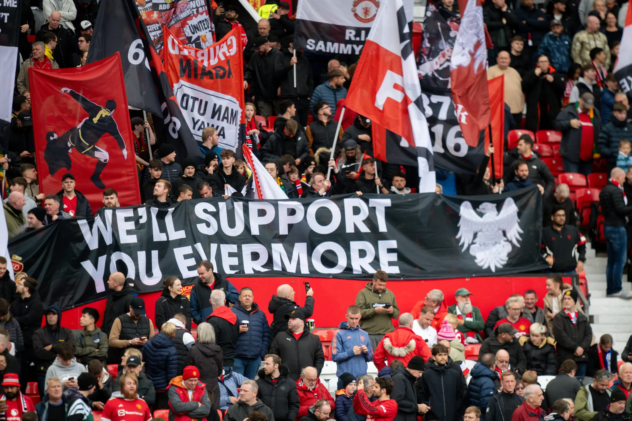 Manchester United fans at Old Trafford with 'We'll support you evermore' banner
