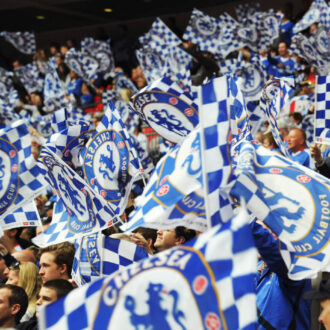 Flags flying at Stamford Bridge with Chelsea FC logos on them.