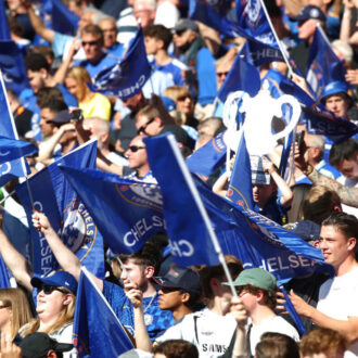 Chelsea FC fans celebrating at Stamford Bridge.