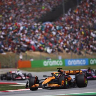 F1 Spanish Grand Prix action shot with crowd watching on in the background.