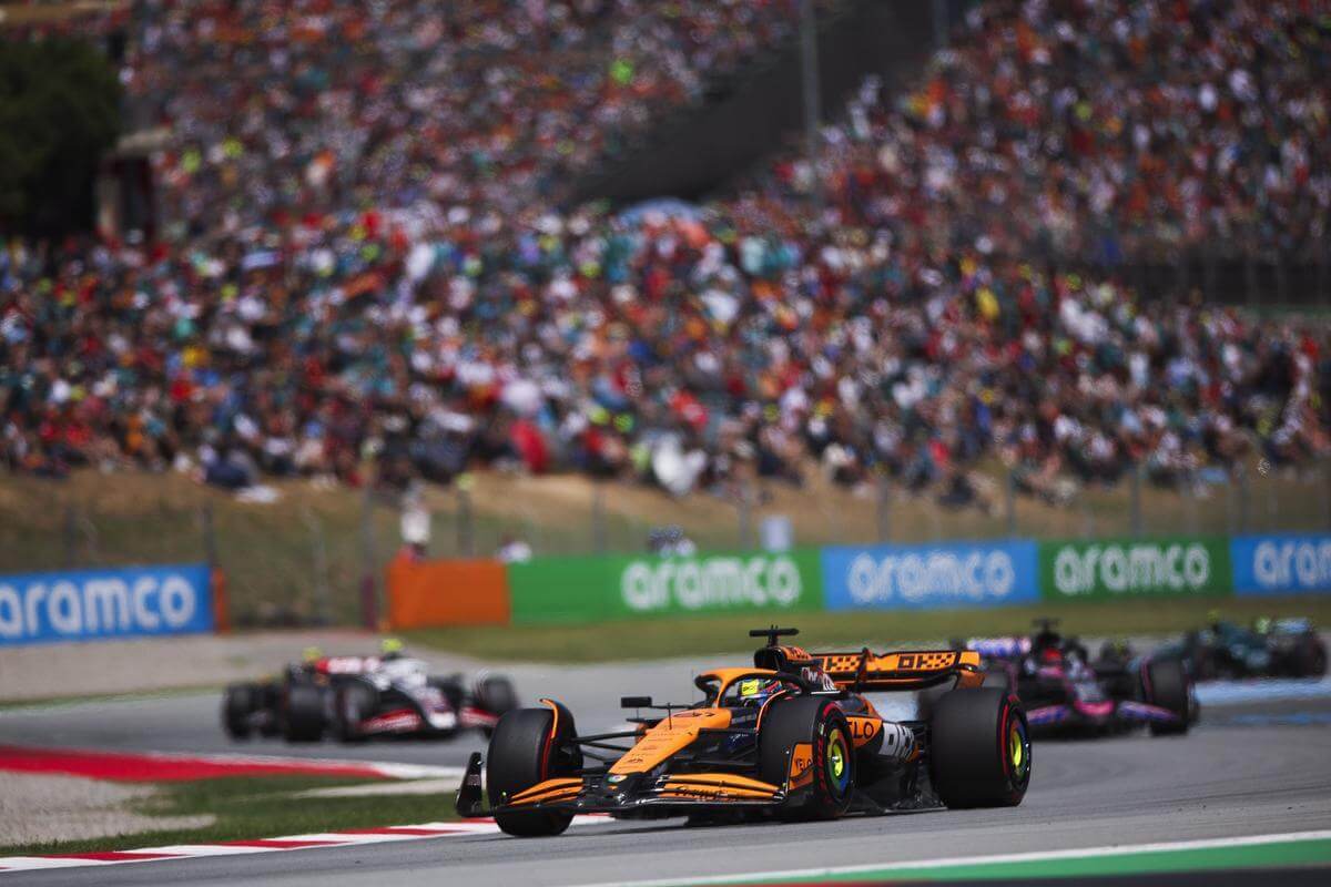 F1 Spanish Grand Prix action shot with crowd watching on in the background.