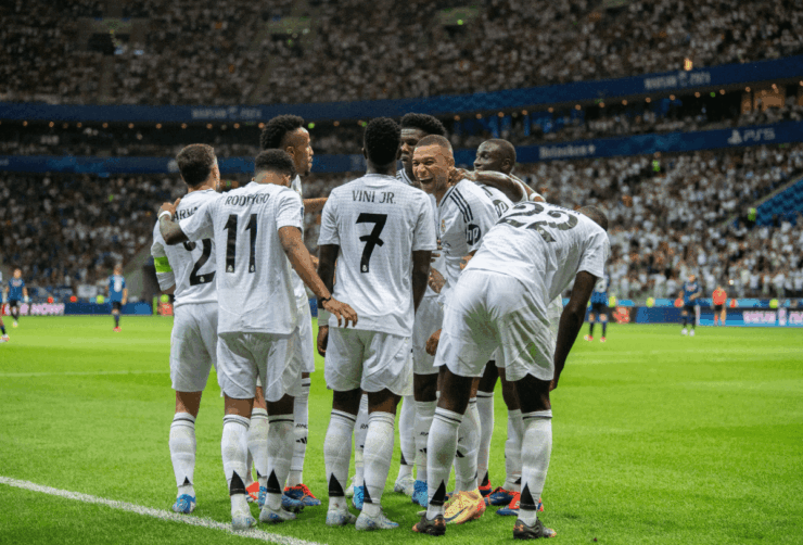 Real Madrid players celebrating together.