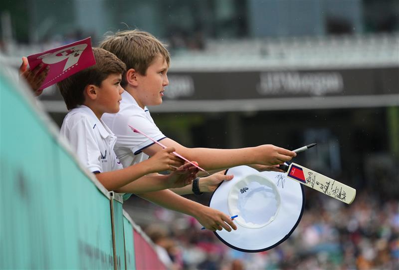 Children with signed merchandise from players at Lord's Cricket Ground.
