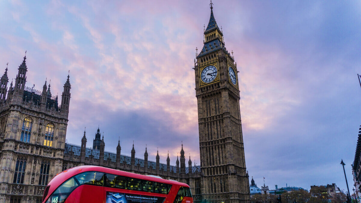 London city scape, with London red bus driving past.
